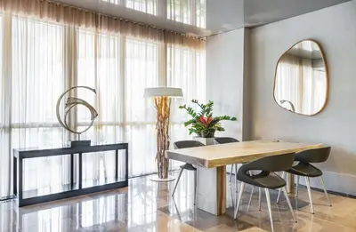 a dining room with a table and chairs at Hilton Bentley Miami South Beach in Miami Beach