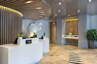 a lobby of a store with white counters and plants at Hilton Bentley Miami South Beach in Miami Beach