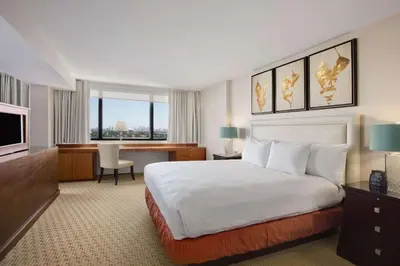 a hotel room with a large bed and a desk at Hilton Miami Airport Blue Lagoon in Miami