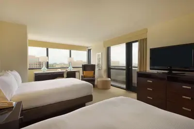 a hotel room with two beds and a flat screen tv at Hilton Miami Airport Blue Lagoon in Miami