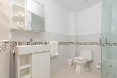a bathroom with a toilet and a sink and a shower at Ocean Drive Studio Historic Building minutes walk to the Beach. in Miami Beach