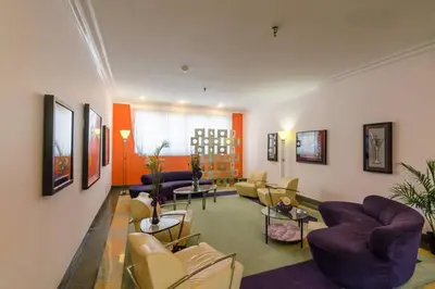 a large living room with couches and chairs at Ocean Drive Studio Historic Building minutes walk to the Beach. in Miami Beach