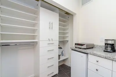 a kitchen with white cabinets and a counter top at Ocean Drive Studio Historic Building minutes walk to the Beach. in Miami Beach