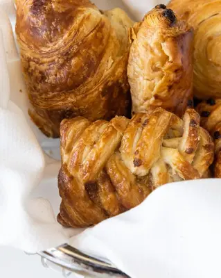 a pile of pastries in a box with a fork at Element Fort Lauderdale Downtown in Fort Lauderdale
