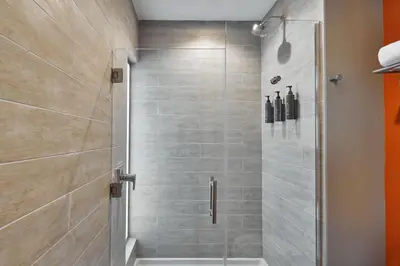 a shower with a glass door in a bathroom at Aloft Miami Aventura in Aventura