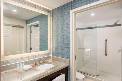 a bathroom with a sink and a shower at Homewood Suites Miami Airport/Blue Lagoon in Miami