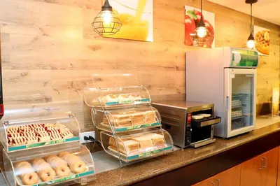a bakery with donuts on display on a counter at Quality Inn Miami Airport - Doral in Miami