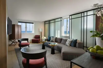 a living room with a couch and a table at Hotel Victor South Beach in Miami Beach