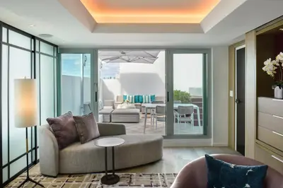 a living room with a couch and a table at Hotel Victor South Beach in Miami Beach