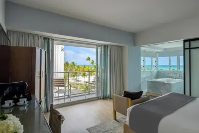 a hotel room with a bed and a view of the ocean at Hotel Victor South Beach in Miami Beach