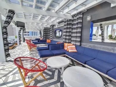 a lobby with a blue couch and chairs at 1201 W Residences in Fort Lauderdale