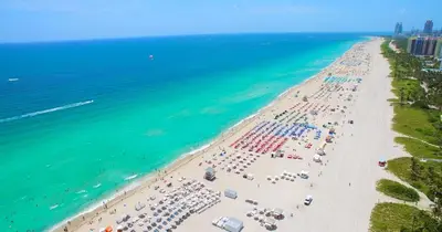 an overhead view of a beach with umbrellas and the ocean at Oceanview Private Condo at 1 Hotel & Homes -915 in Miami Beach