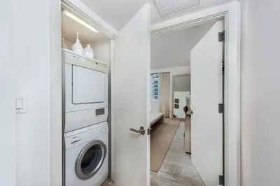 a white laundry room with a washer and dryer at Oceanview Private Condo at 1 Hotel & Homes -1208 in Miami Beach