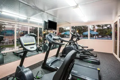 a gym with treadmills and elliptical machines at enVision Hotel Miami International Airport in Miami