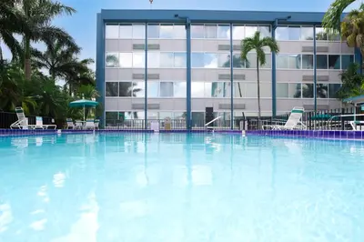 a large swimming pool in front of a building at enVision Hotel Miami International Airport in Miami