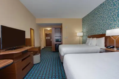 a hotel room with two beds and a flat screen tv at Fairfield Inn & Suites By Marriott Fort Lauderdale Downtown/Las Olas in Fort Lauderdale