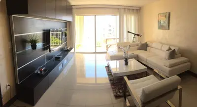 a living room with a couch and a table at Sunny Isles Ocean Reserve Condo Apartments in Miami Beach