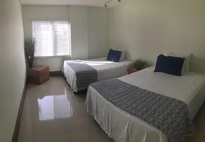 a room with two beds and a window at Sunny Isles Ocean Reserve Condo Apartments in Miami Beach