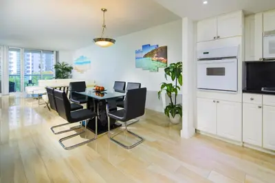 a kitchen and dining room with a table and chairs at Sunny Isles Ocean Reserve Condo Apartments in Miami Beach