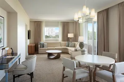 a living room with a couch and a table and chairs at JW Marriott Miami Turnberry Resort & Spa in Aventura
