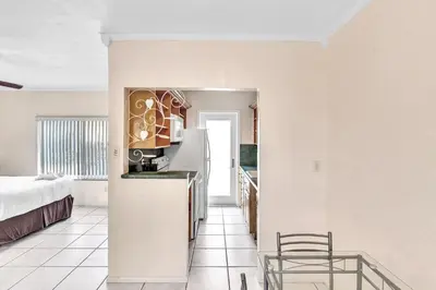 a kitchen with a refrigerator and a bed in a room at Silver Spray Motel in Hollywood