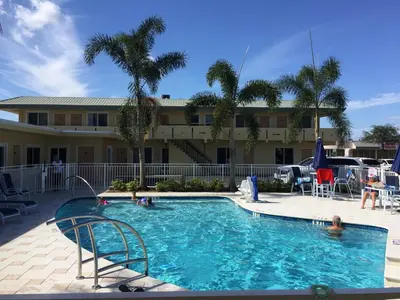 a large swimming pool with people in a resort at Curtis Inn & Suites in Hollywood