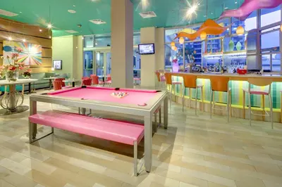 a pink ping pong table in a restaurant with a bar at Hampton Inn & Suites by Hilton Miami Downtown/Brickell in Miami