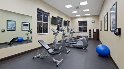 a gym with treadmills and ellipticals in a room at Best Western Plus Miami Intl Airport Hotel & Suites Coral Gables in Miami