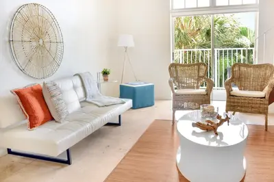 a living room with a white couch and chairs at Coral Reef at Key Biscayne in Miami