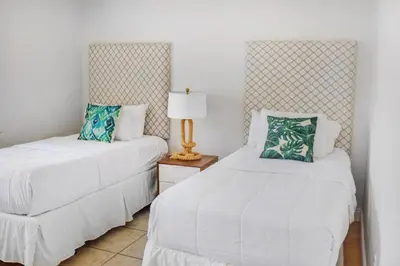 a bedroom with two beds and a lamp on a table at Coral Reef at Key Biscayne in Miami