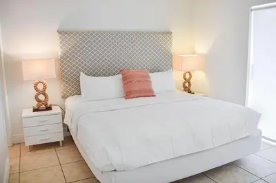a bedroom with a white bed and two lamps at Coral Reef at Key Biscayne in Miami