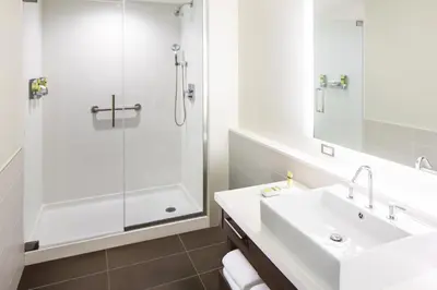a white bathroom with a sink and a shower at Element Miami International Airport in Miami