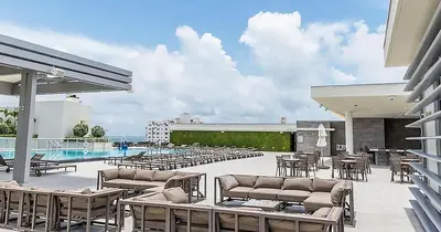 a patio with tables and chairs and a pool at Global Rent Apart - Costa Hollywood in Hollywood