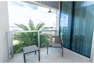 a balcony with a chair and a large window at Global Rent Apart - Costa Hollywood in Hollywood
