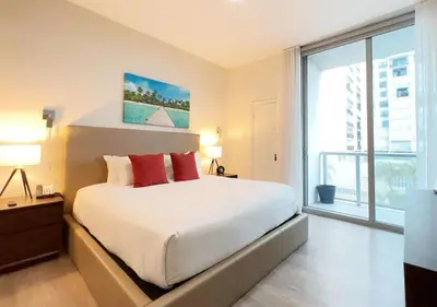 a bedroom with a large bed and a large window at Global Rent Apart - Costa Hollywood in Hollywood
