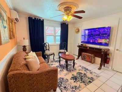 a living room with a couch and a flat screen tv at Sinclair Boutique Hotel in Hollywood