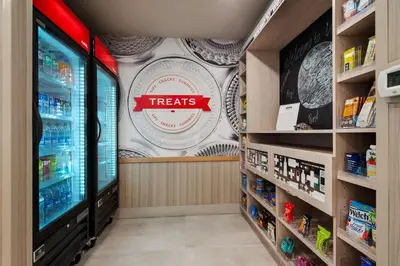 a grocery store aisle with a treats sign on the wall at Hampton Inn Weston Fort Lauderdale in Weston