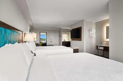 a hotel room with two beds and a television at Hampton Inn Weston Fort Lauderdale in Weston