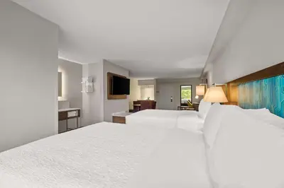a hotel room with two beds and a television at Hampton Inn Weston Fort Lauderdale in Weston