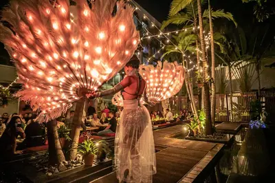a woman in a dress holding a large umbrella at Boulan South Beach in Miami Beach