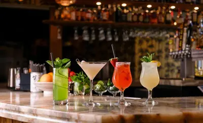 a group of four cocktails sitting on a bar at Boulan South Beach in Miami Beach