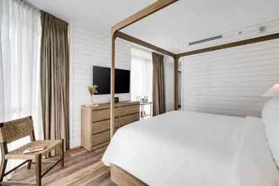 a bedroom with a white bed and a television at Boulan South Beach in Miami Beach