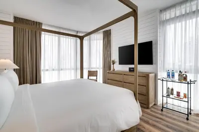 a bedroom with a large bed and a television at Boulan South Beach in Miami Beach
