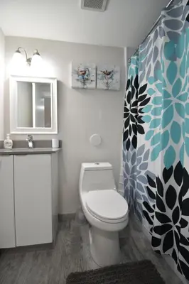 a bathroom with a toilet and a sink at Modern loft wqueen bed steps to beach in Hollywood