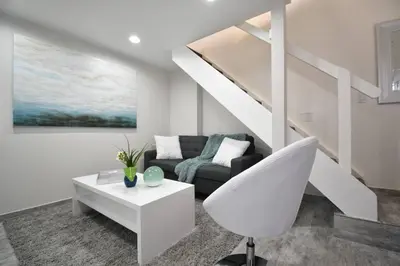 a white living room with a couch and a table at Loft wqueen loft beach steps in Hollywood