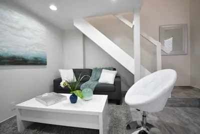 a living room with a couch and a chair at Loft wqueen loft beach steps in Hollywood