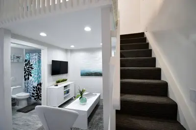 a living room with a staircase and a bathroom at Loft wqueen loft beach steps in Hollywood