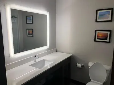 a bathroom with a sink and a mirror at Comfort Suites Fort Lauderdale Airport & Cruise Port in Dania Beach