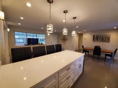 a kitchen and dining room with a table and chairs at Lakefront Vacation Home - Sleeps 8 in Davie