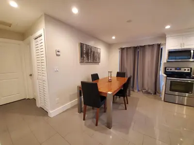 a dining room with a wooden table and chairs at Lakefront Vacation Home - Sleeps 8 in Davie